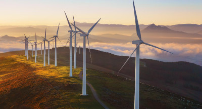 A wind farm on a hill demonstrating how to achieve net-zero housing developments