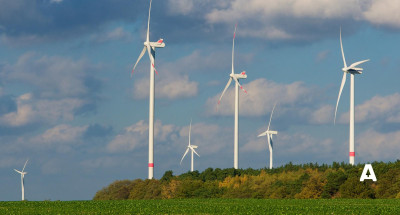 Multiple wind turbines on a hill showing a good site for wind turbine site selection and planning