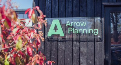 Acrylic sign on Arrow Planning barn wall close up